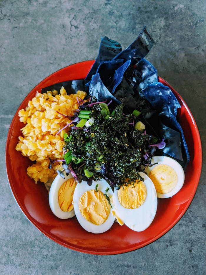 who-we-are A vibrant and nutritious bowl featuring eggs, seaweed, and fresh vegetables.