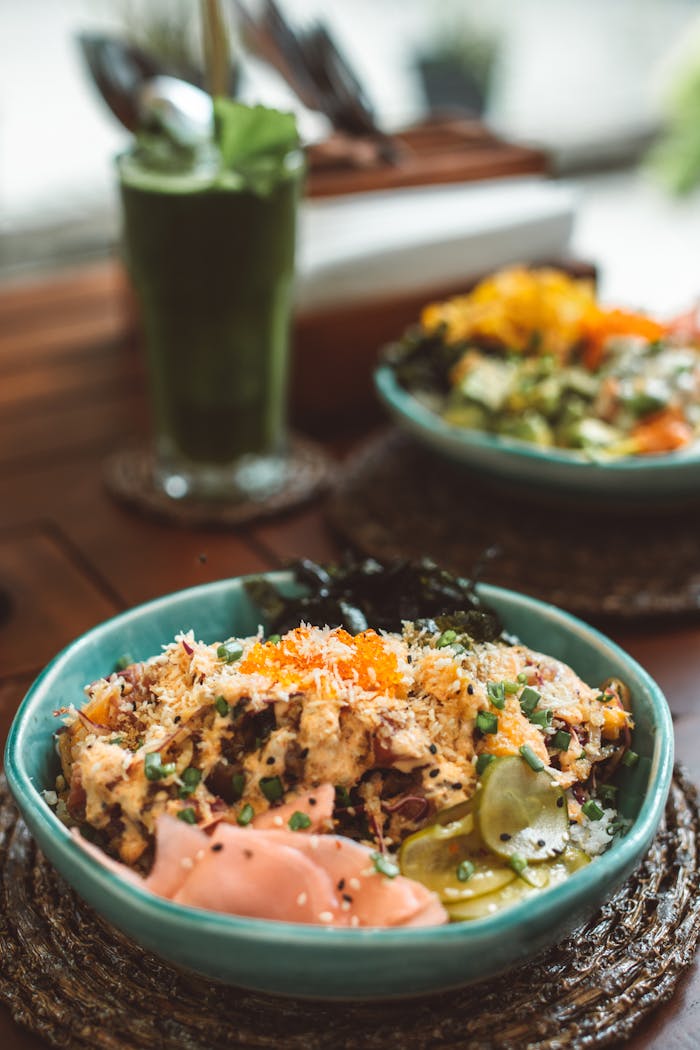 services-02 Delicious Asian-inspired poke bowl served with a green smoothie, ideal for healthy dining.